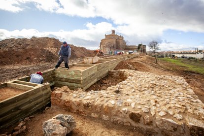 La torre cuadrada con la huella de la circular. Al fondo se ve la otra redonda. Las cajas de madera señalan la muralla ‘robada’. MARIO TEJEDOR