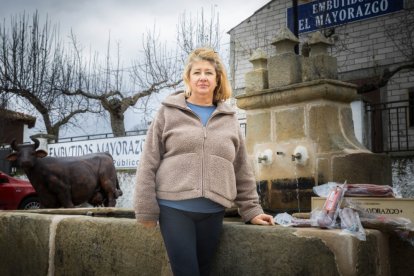 Pilar Escobar posa junto a algunos de los productos de Embutidos El Mayorazgo enfrente de su obrador.