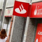 Una agencia del Santander junto a otra del Popular.-REUTERS / ALBERT GEA
