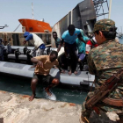 Inmigrantes llegan a la base naval libia después de haber sido rescatados por guardacostas libios en la costa de Trípoli.-REUTERS