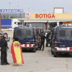 Una mujer con la bandera española habla con los Mossos, en la frontera con la Junquera.-JOAN CASTRO / ICONNA