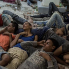 Supervivientes del naufragio duermen en una comisaría tras ser rescatados.-AP / EMAN HELAL