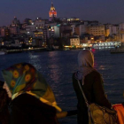 Varias mujeres con pañuelo y sin él fotografían el paisaje de Estambul desde el puente de Galata, el 23 de febrero.-GETTY IMAGES / CHRIS MCGRATH