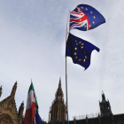 Un manifestante sostiene las bandera de Gran Bretaña y de la UE en una protesta ante el Parlamento británico, en Londres.-FRANK AUGSTEIN (AP)