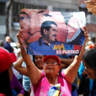 Una mujer, con una pancarta de apoyo a Maduro, el domingo, en Caracas-REUTERS / CHRISTIAN VERÓN