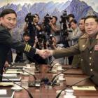 El general norcoreano An Ik San (derecha) da la mano a su homólogo surcoreano, Kim Do-gyun.-YONHAP