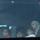 Una mujer y sus hijos, a bordo del autobús que les ha sacado del campo de Idomeni, esta mañana.-AP