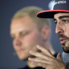 Fernando Alonso con Valtteri Bottas, al fondo, en Abu Dhabi.-VALDRIN XHEMAJ (EFE)