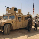 Combatientes de las Fuerzas Democráticas Sirias junto a vehículos militares de EEUU en las afueras de Manbij, en la provincia de Alepo, el 7 de marzo.-AP