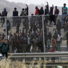 Inmigrantes subsaharianos encaramados a la valla de Melilla.-Foto:   EFE / PACO GUERRERO