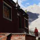 Un monje tibetano junto a la entrada del templo budista del monte Kailash en Ngari (Tíbet).-JACKY CHEN / REUTERS