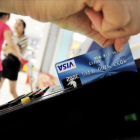 Una mujer usa su tarjeta de crédito.-AFP/FRANKO LEE