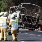 Restos calcinados del autocar.-AFP