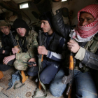 Rebel fighters ride a military vehicle, as they advance towards the northern Syrian town of al-Bab, Syria January 15, 2017.-KHALIL ASHAWI / REUTERS