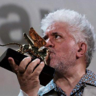 Pedro Almodóvar besa el León de Oro a su carrera cinematográfica, en Venecia, este jueves.-MANUEL SILVESTRI