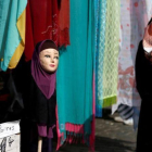 Una mujer musulmana pasa junto a una tienda de venta de pañuelos islámicos en Bruselas.-REUTERS / FRANCOIS LENOIR