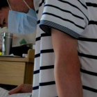 Li Haiqing, de 26 años, leyendo el prospecto farmacéutico de uno de los medicamentos que debe tomar a causa de su enfermedad.-BBC WORLD / PEKÍN