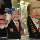 La empleada de una tienda de 'souvenirs' de Moscú saca brillo a las matrioskas de Trump y Putin, a cuatro días de la investidura del primero como presidente de EEUU.-AFP