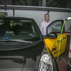 Un taxista carga su vehículo eléctrico en el aparcamiento de su comunidad de vecinos.-JOAN PUIG