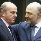 El ministro Luis de Guindos conversa con el comisario de Asuntos Economicos, Pierre Moscovici, en Bruselas el 14 de enero.-OLIVIER HOSLET