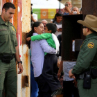 Un hombre abraza a un niño en la frontera con México en California, el pasado 19 de noviembre.-REUTERS / MIKE BLAKE