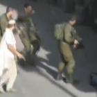 Un colono, con un pistola, tras abatir a un palestino en Hebrón.-