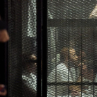 Uno de los detenidos sigue el juicio en una jaula de cristal.-AFP / MOHAMED EL-SHAHED