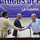 El comandante de las FARC y líder del equipo negociador de paz Luciano Marin 'Ivan Marquez' estrecha la mano del jefe negociador del Gobierno colombiano  Humberto de la Calle, el viernes.-ERNESTO MASTRASCUSA