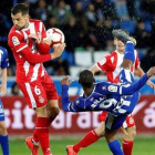 El delantero uruguayo del Alavés Diego Rolan remata ante el centrocampista del Girona Alex Granell.-