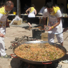 Los miembros de las Peñas preparando sus paellas ayer en la plaza del Rastro. / JAVIER NICOLAS -