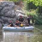 Policías del grupo de actividades acuáticas sondeando el río.