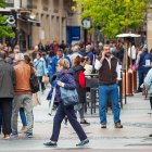 Personas pasean por una concurrida calle del centro de Soria.