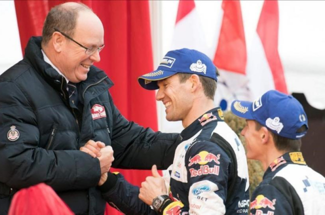 Sébastien Ogier estrecha la mano del príncipe Alberto de Mónaco junto a su copiloto, Julien Ingrassia, este domingo en Mónaco.-AFP / YANN COATSALIOU