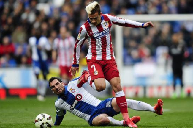 Abraham y Griezmann peleam por el balón, en un momento del partido que ha enfrentado al Espanyol y el Atlético en Cornellà.-Foto: AP / MANU FERNÁNDEZ