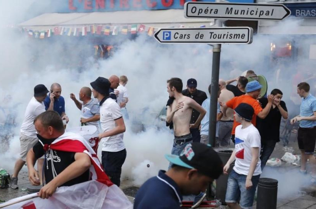 Aficionados ingleses corren tras el lanzamiento de gases lacrimógenos por la policía en Marsella.-DARKO BANDIC