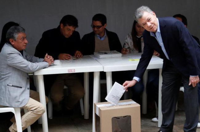 El presidente colombiano, Juan Manuel Santos, en el momento de depositar su voto en Bogotá.-REUTERS / CARLOS GARCIA RAWLINS