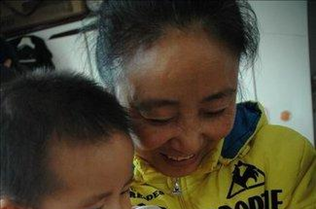 Un niño da el biberón a otro en Wu, China.-EFE EPA / HAO QY CHINA OUT