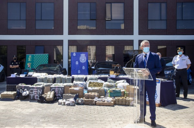 Cientos de kilos de droga ante coches de alta gama en la presentación de la operación policial. ICAL