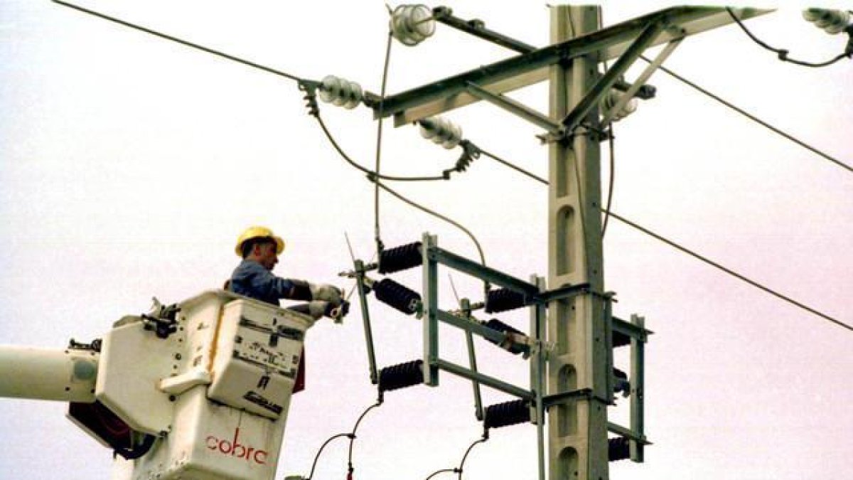 Un equipo técnico repara un poste de electricidad.-JOAN PUIG