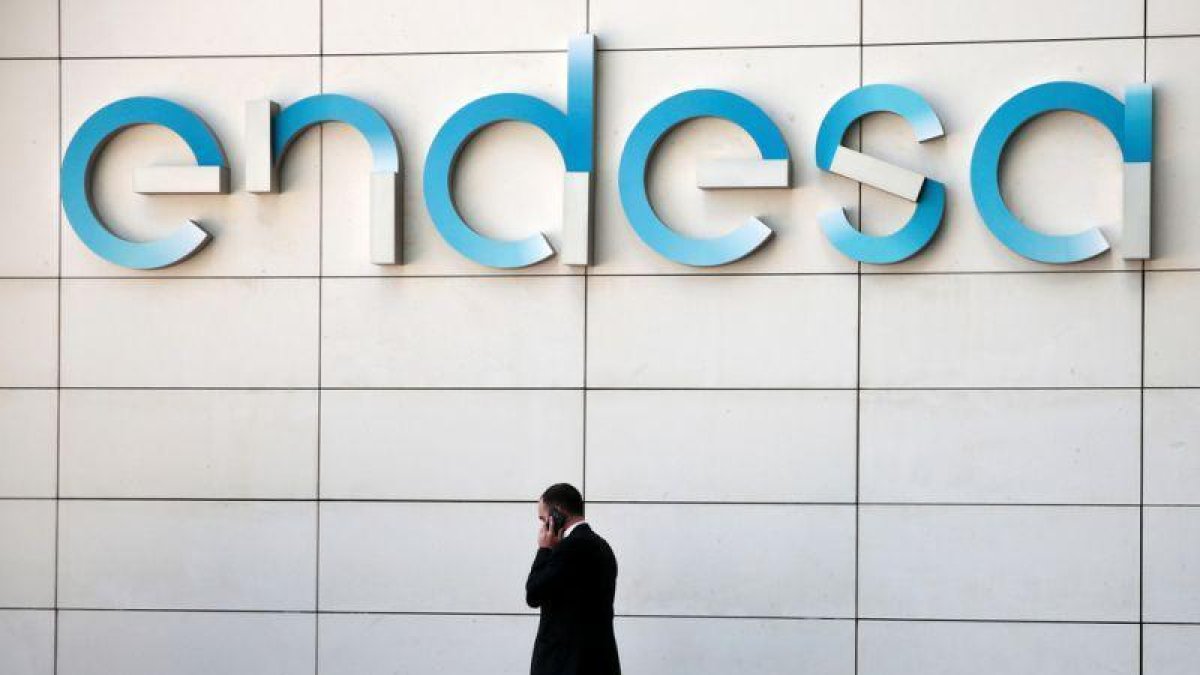 Un hombre camina bajo el logo de Endesa en la sede de la empresa en Madrid.-ANDREA COMAS / REUTERS