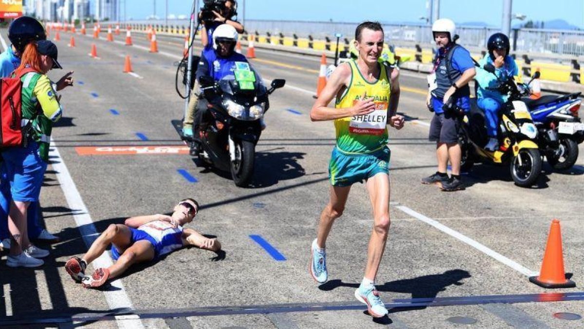 El escocés Hawkins, tendido en el asfalto, tras sufrir un colapso en el maratón disputado en Australia.-EFE / TRACEY NEARMY