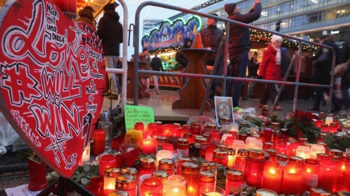 Visitantes caminan en el memorial improvisado en el reabierto mercadillo navideño de Breitscheldplatz, este jueves.-GETTY / SEAN GALLUP