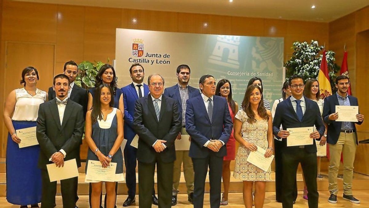 Fotografía de familia de los 14 médicos y enfermeros residentes distinguidos, con el presidente de la Junta, Juan Vicente Herrera, y el consejero de Sanidad, Antonio María Sáez.-ICAL