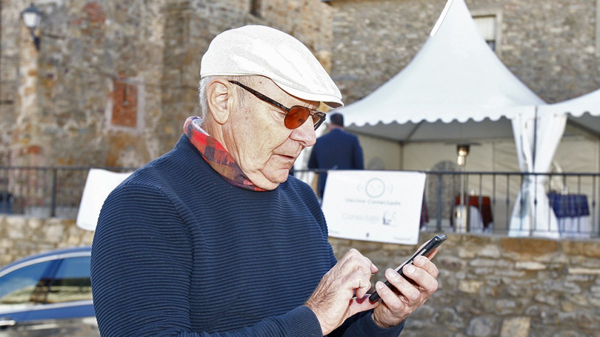 Una persona busca Internet con su móvil en el medio rural.-MARIO TEJEDOR