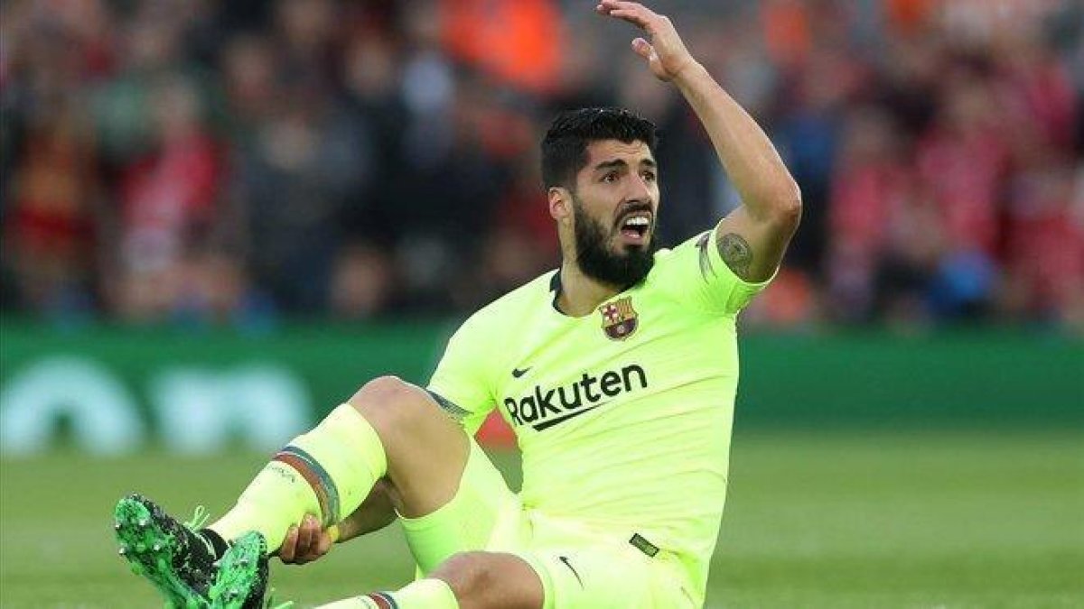 Suárez se lamenta en Anfield donde sufrió una rotura de menisco.-REUTERS / CARL RECINE