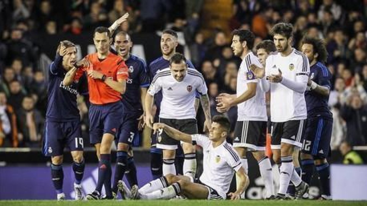 Los jugadores del Madrid protestan al árbitro Sánchez Martínez tras la expulsión de Kovacic en Mestalla.-MIGUEL LORENZO