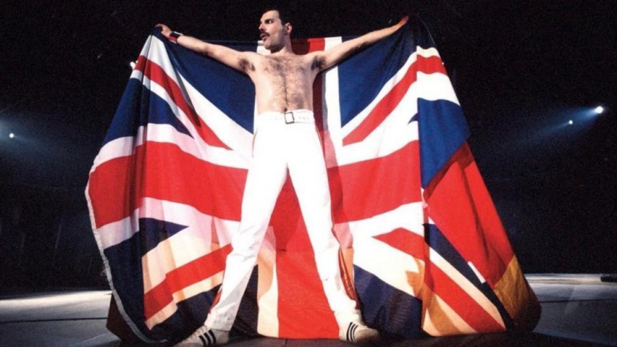 Freddie Mercury sostiene la bandera de Reino Unido durante un concierto con su grupo, 'Queen'.-