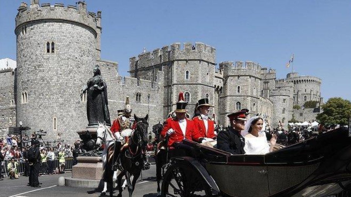 Meghan y Enrique dejan en carroza el castillo de Windsor tras su boda, en mayo del 2018.-