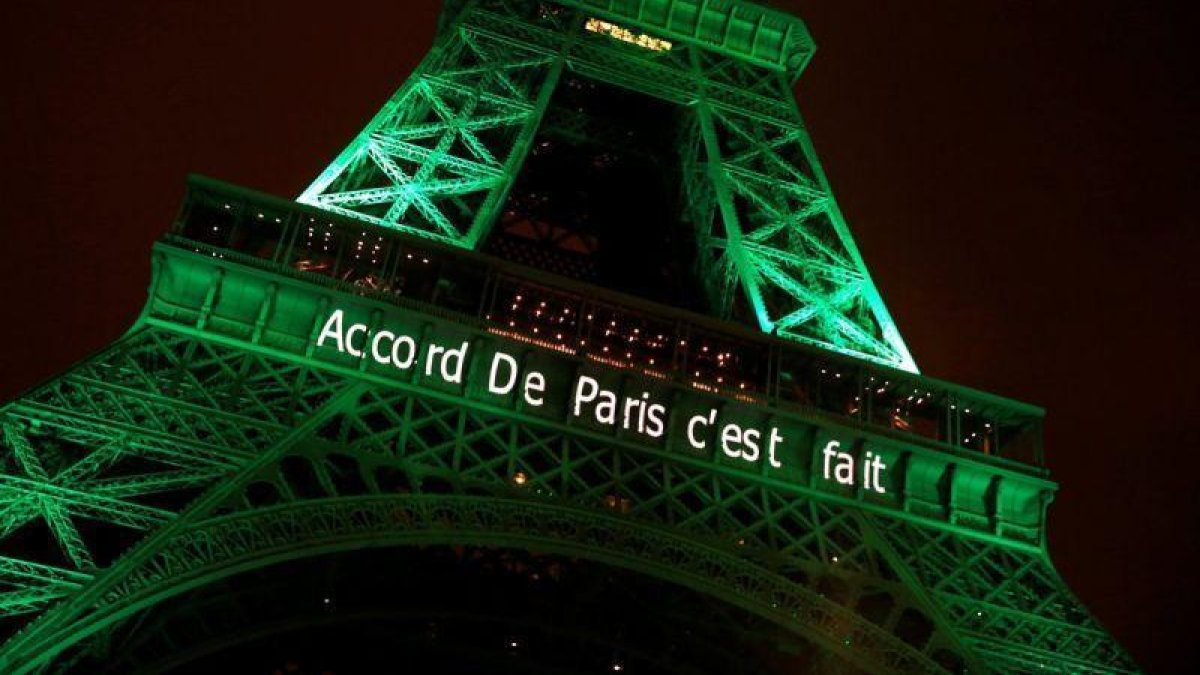 La torre Eiffel de París, iluminada de color verde para celebrar la firma de los acuerdos contra el cambio climático por parte de la comunidad internacional.-JACKY NAEGELEN (REUTERS)