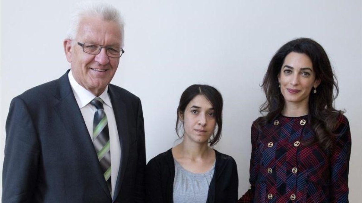 El jefe del Gobierno regional de Baden-Wurttemberg, Winfried Kretschmann, la joven yazidi Nadia Murad y la abogada Amal Clooney, en Stüttgart.-EFE / BERND WEISSBROD